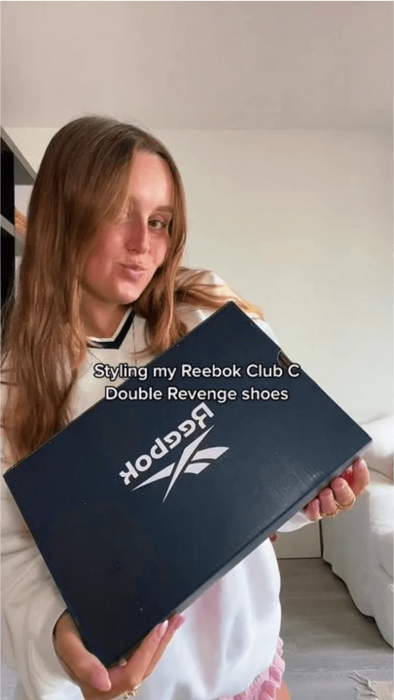Still of TikTok creator trying on Reebok Club C shoes