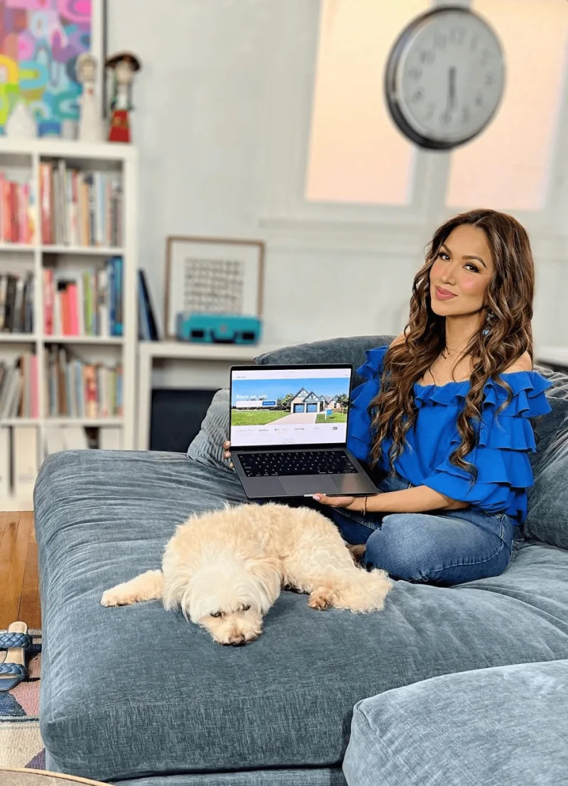 Creator searches for homes on OpenDoor on a blue couch with a small dog