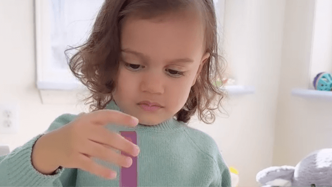 Child plays with wooden toy next to key campaign results
