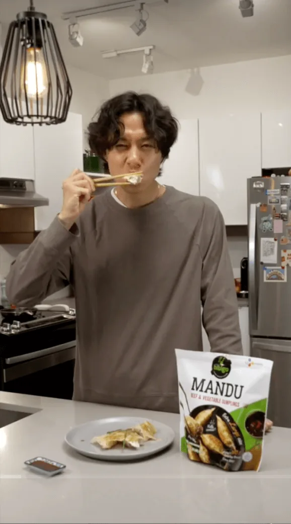Creator eats bibigo Mandu dumplings with chopsticks next to key campaign results