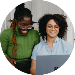 2 people working at a marketing agency review content on their laptop together