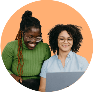 2 people working at a marketing agency review content on their laptop together