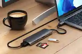 Kannettava kiinni telakassa yhdellä USB-C-johdolla, joka on kiinni näytössä näyttökaapelilla.