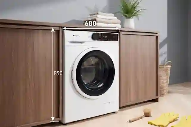 White Ströme washing machine in a walnut laundry room cabinet. Dimensions: 850 mm high, 600 mm wide.