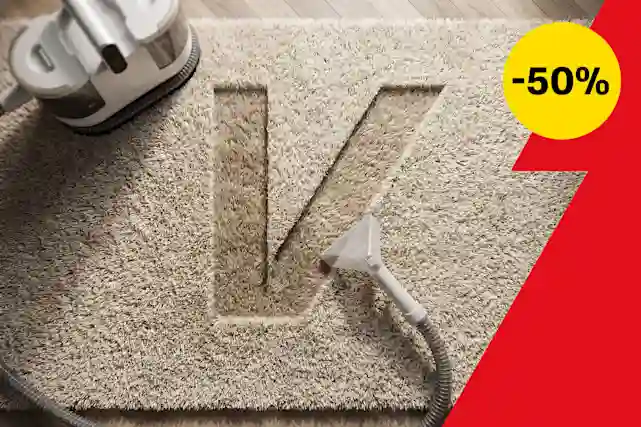 Maton syväpuhdistuslaite puhdistaa vaaleaa mattoa, ja puhdistettu alue muodostaa V-kirjaimen muodon. Oikealla punainen V-grafiikka ja keltainen huomiopallo, jossa lukee −50 %.