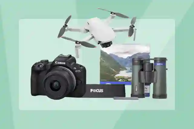 Kuvassa Canon järjestelmäkamera, DJI:n drone ja Focuksen kiikarit. Taustalla vihreä V-logo