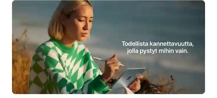 A woman in a green and white sweater uses a tablet outdoors. Text: True portability that lets you do anything.