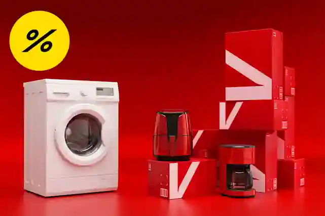 Varaston perukoilta edullisia kodinkoneita punaisten Verkkokauppa.com pahvilaatikoiden vieressä. Osa tuotteista kulkeutuu kotiin toimitettuna tunnissa. Ostoksille!