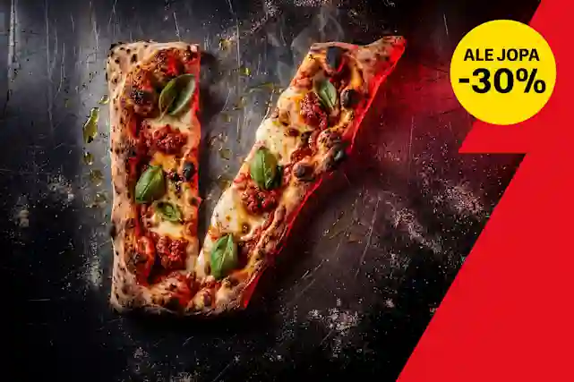 V-kirjaimen muotoinen pitsa rosteri taustalla. Päälle ripoteltu oliiviöljyä. Oikeassa yläkulmassa keltainen pallura, jossa teksti:"Ale jopa -30%". 