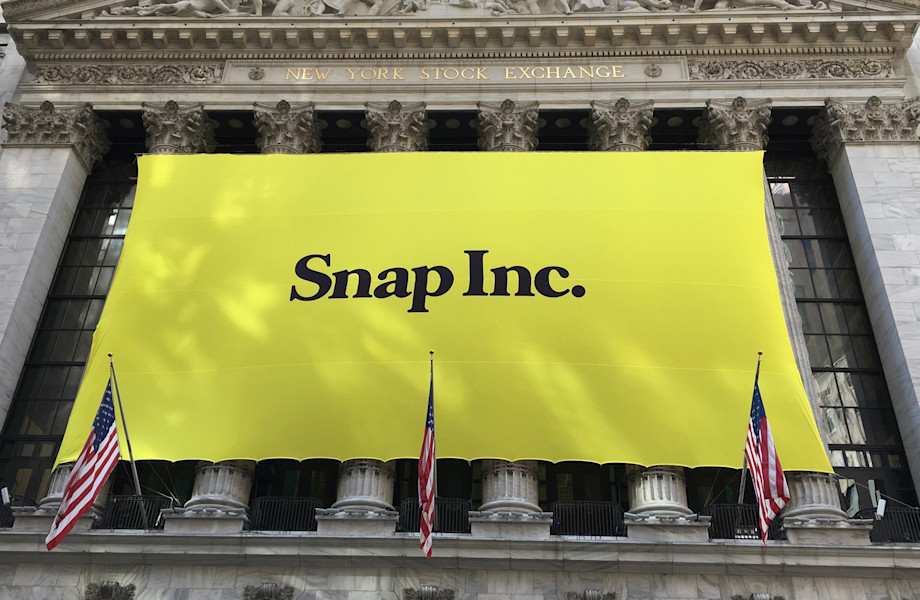 Image of a large yellow Snap Inc. banner hung on the front of the New York Stock Exchange building from the day Snap Inc. went public as a company.