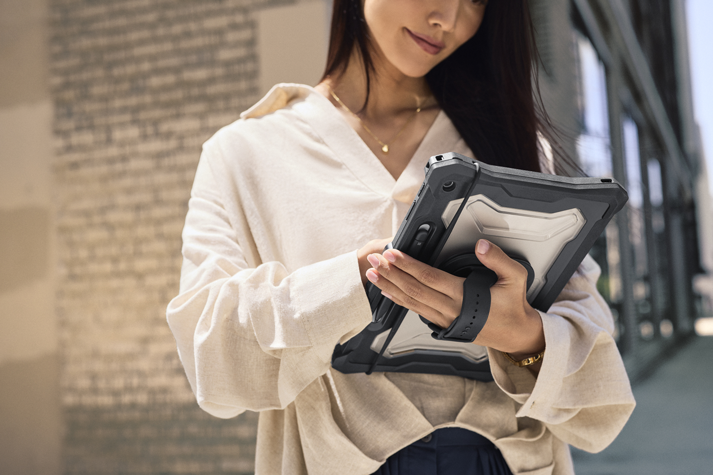 A woman walking in the city working on a Surface Pro