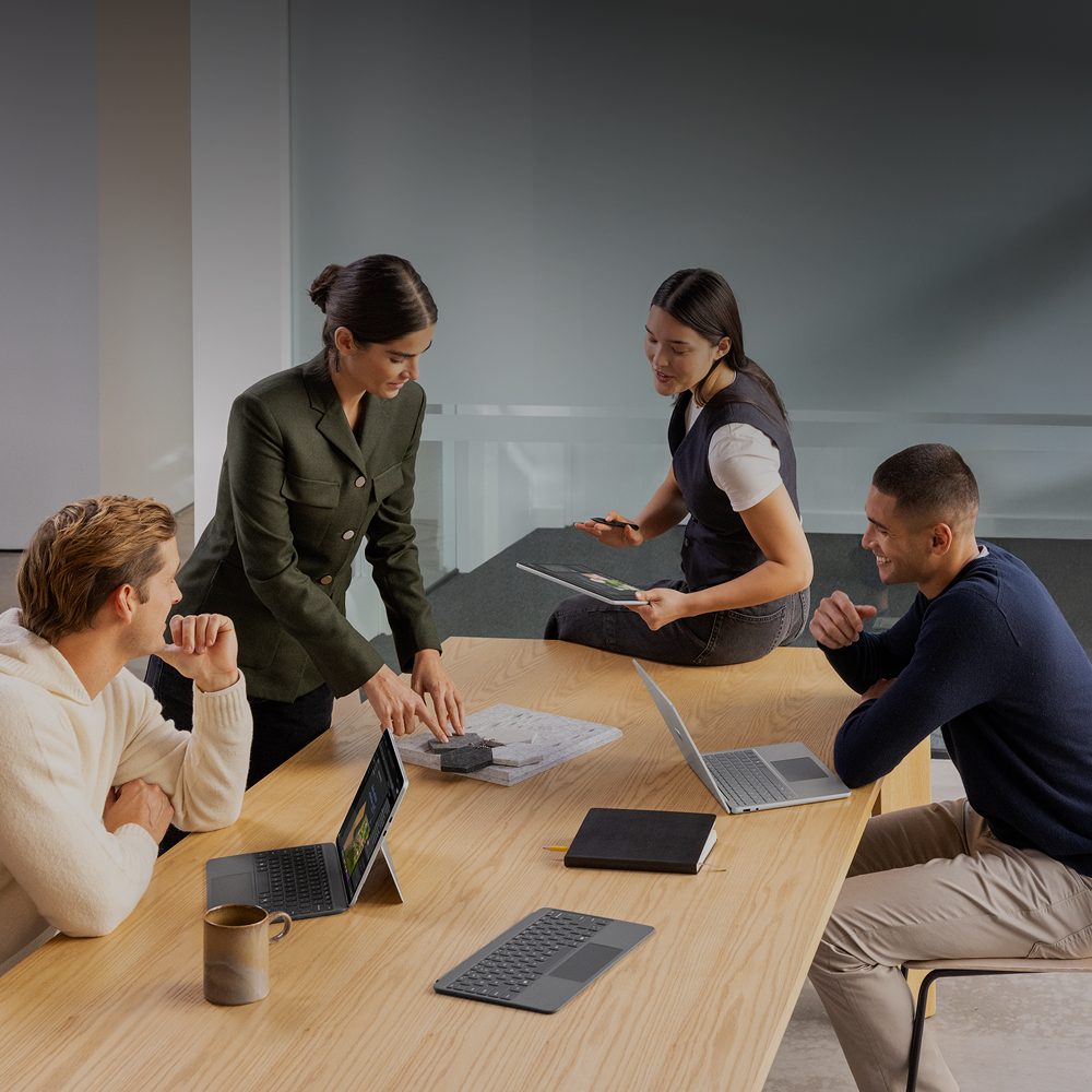 A group of professionals using Surface for Business Laptops and 2-in-1 tablets