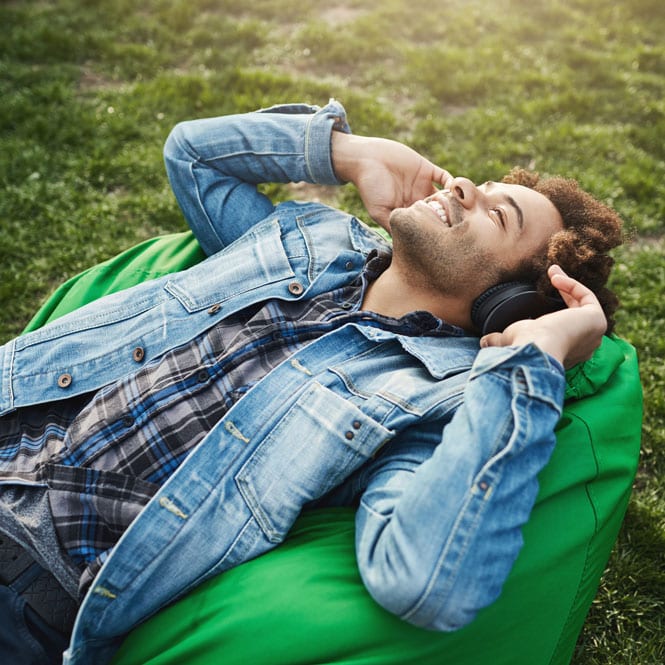 Man on lawn enjoying music