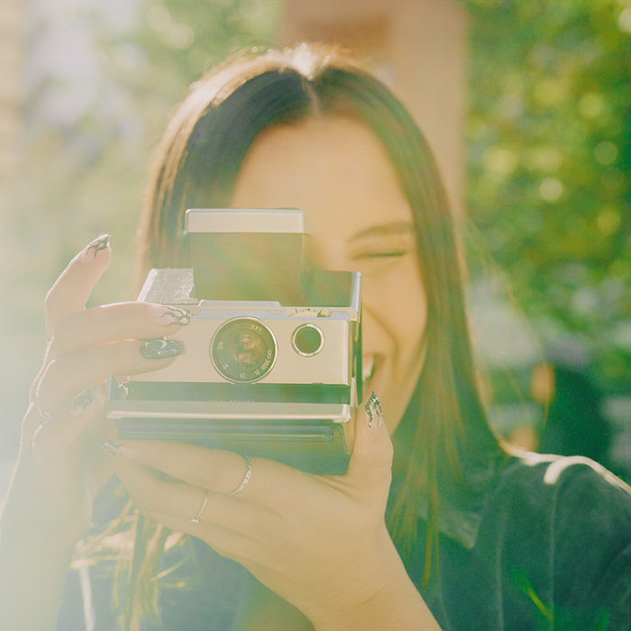 Woman taking a Polaroid picture