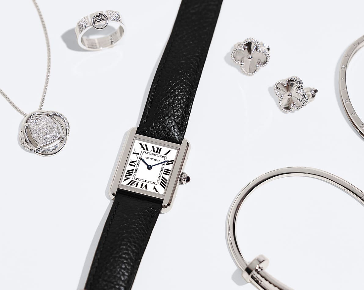 one Cartier Tank watch with a black leather strap, one silver tone David Yurman pendant necklace, one silver tone Hermes Kelly ring, one pair of silver Van Cleef & Arpels Alahambra earrings and one silver Cartier Juste Un Clou bracelet
