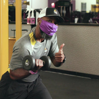 PF Trainer Teddy wearing a mask and giving thumbs up