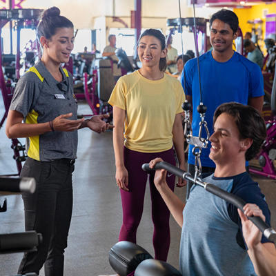 one Planet Fitness trainer and three members 