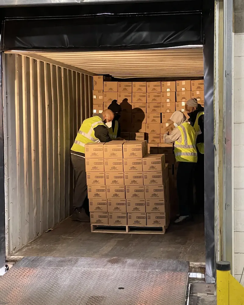 back-of-container-stacks-of-boxes-being-carried-out
