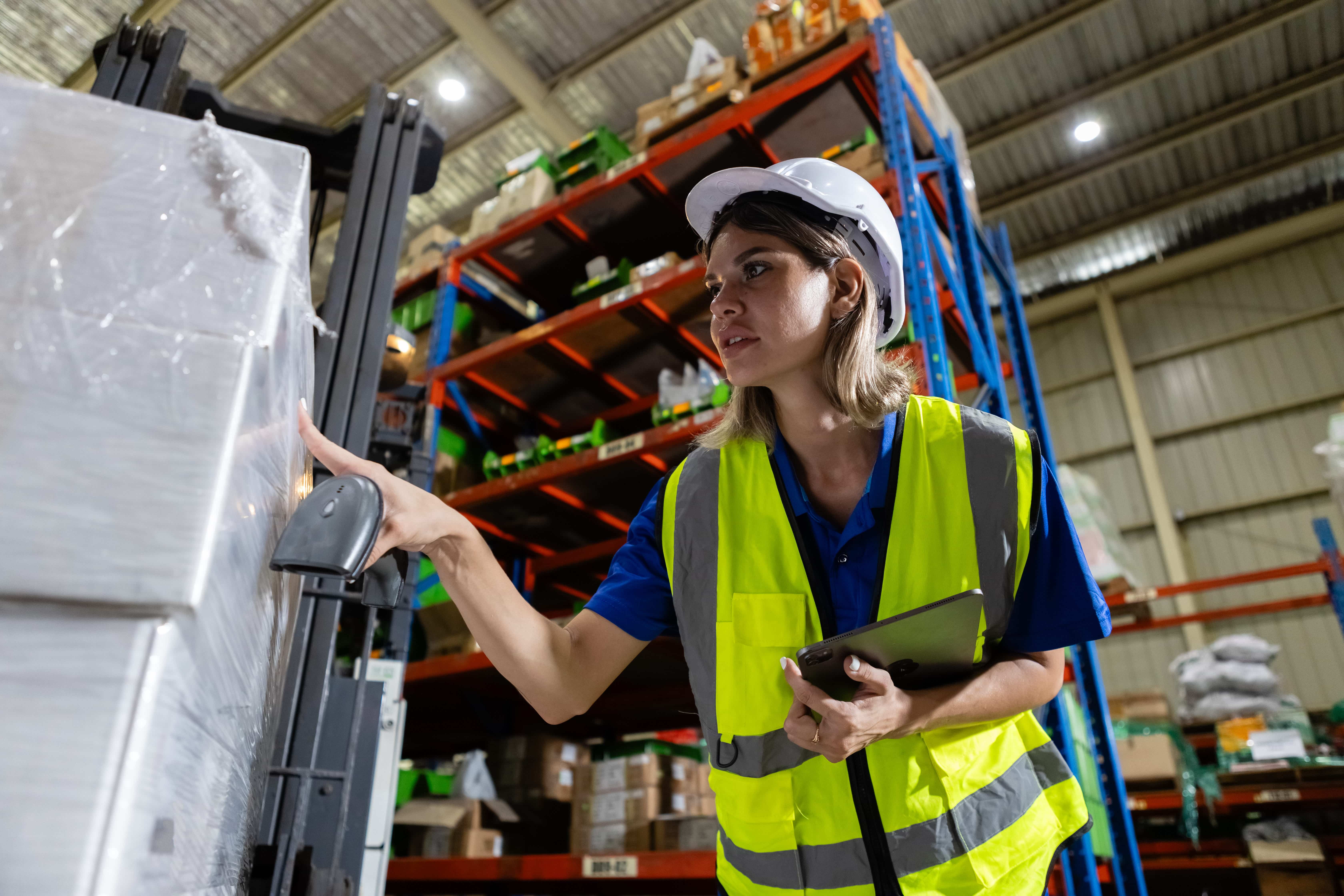 warehouse-worker-scanning-package-with-barcode-rea