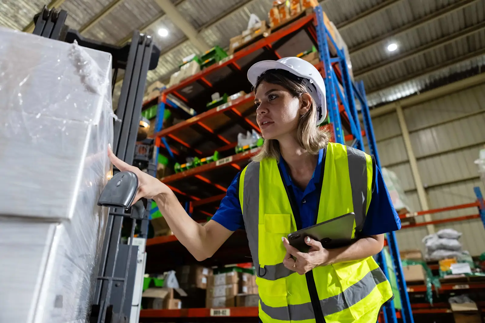 warehouse-worker-scanning-package-with-barcode-rea