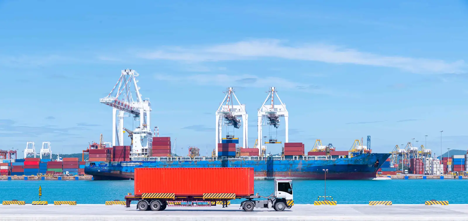 cargo-ship-and-truck-at-seaport-waiting-for-contai-2026-03-24-09-05-36-utc (1)