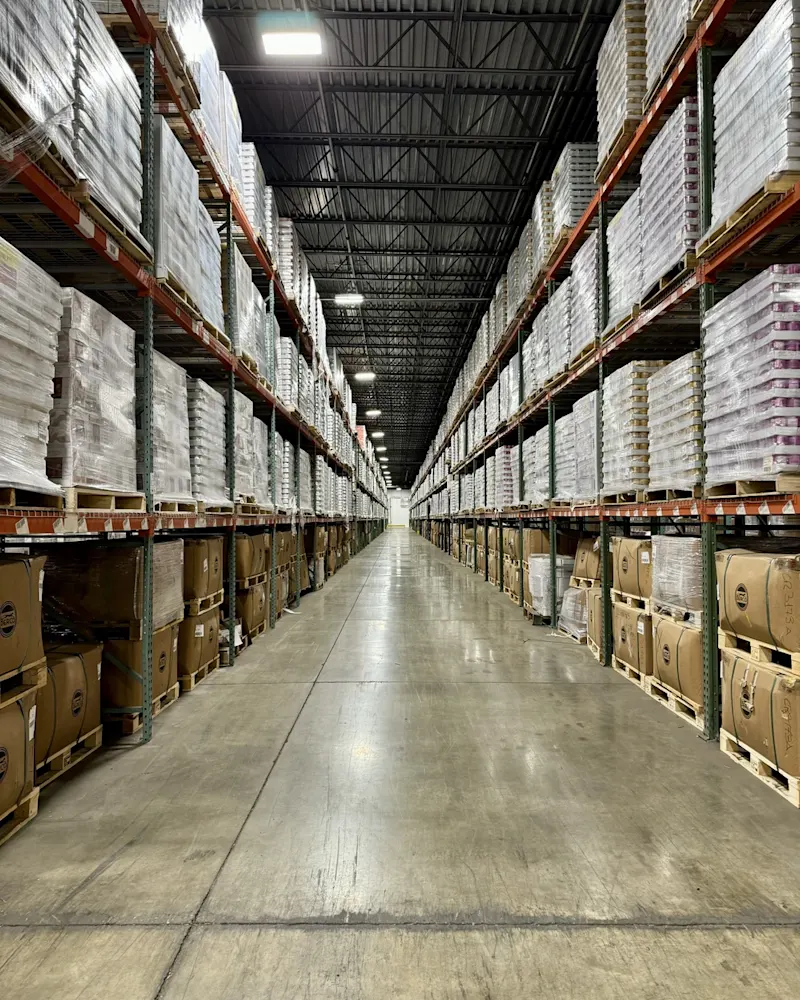 warehouse-interior-large-blocks-of-boxed-cans-deep-hallway-perspective shot