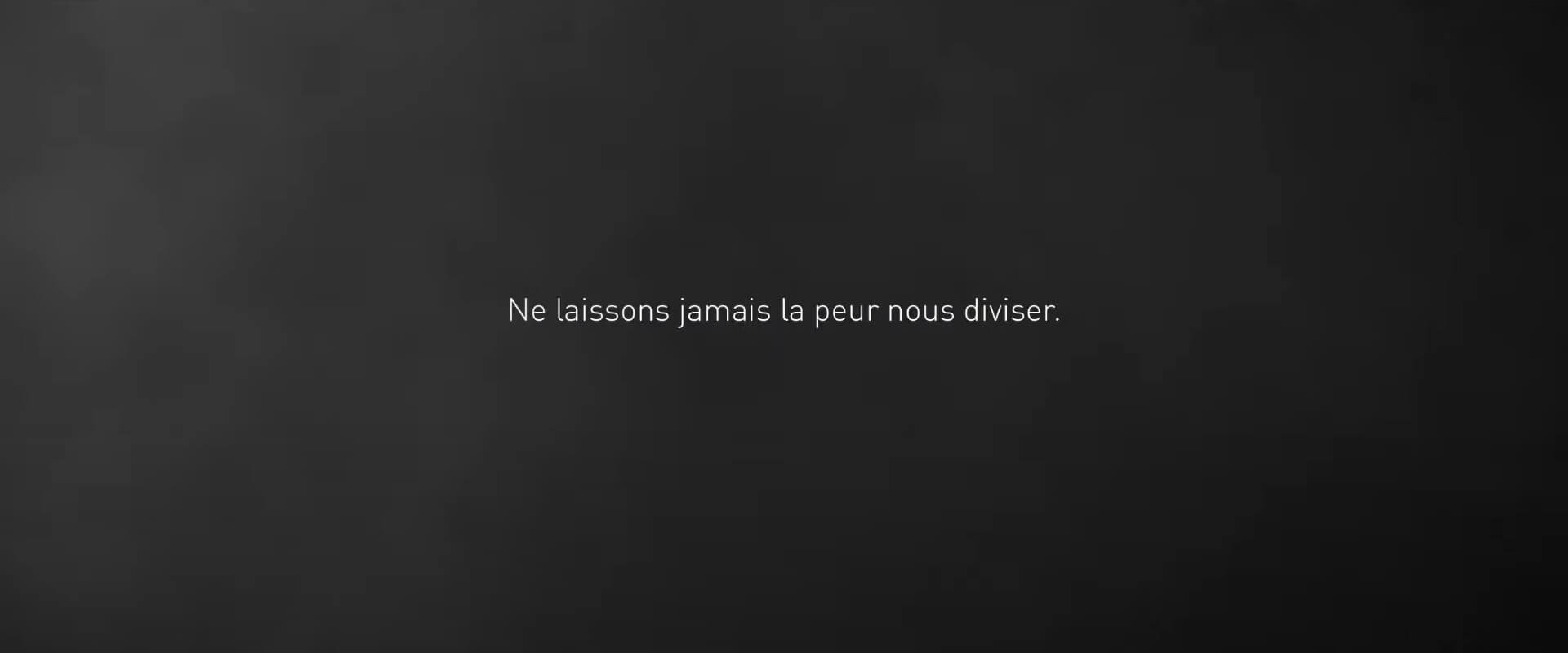 Sentence on black screen: never let the fear divide us 