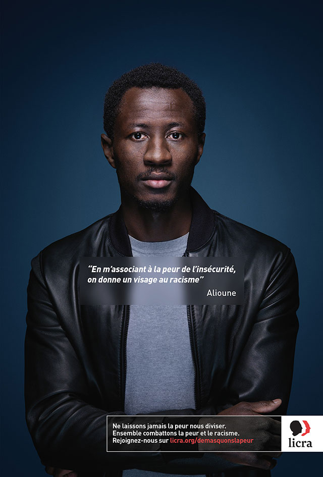 A man standing in front of a blue background