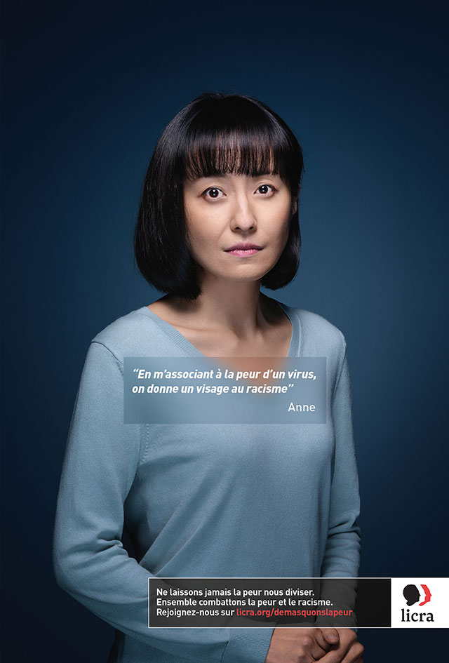 A woman standing in front of a blue background