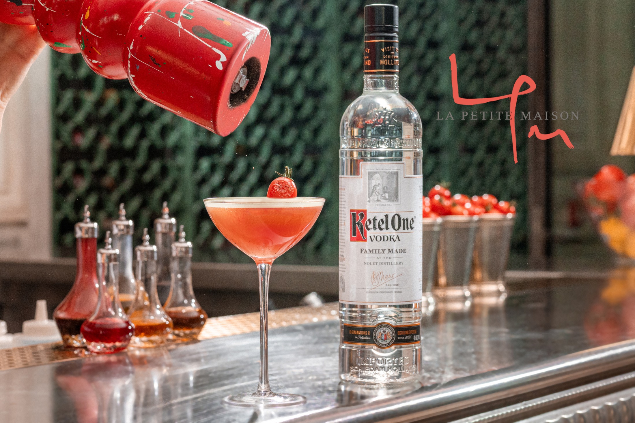 Ketel One Tomatini in a coupe glass with hand grinding pepper.