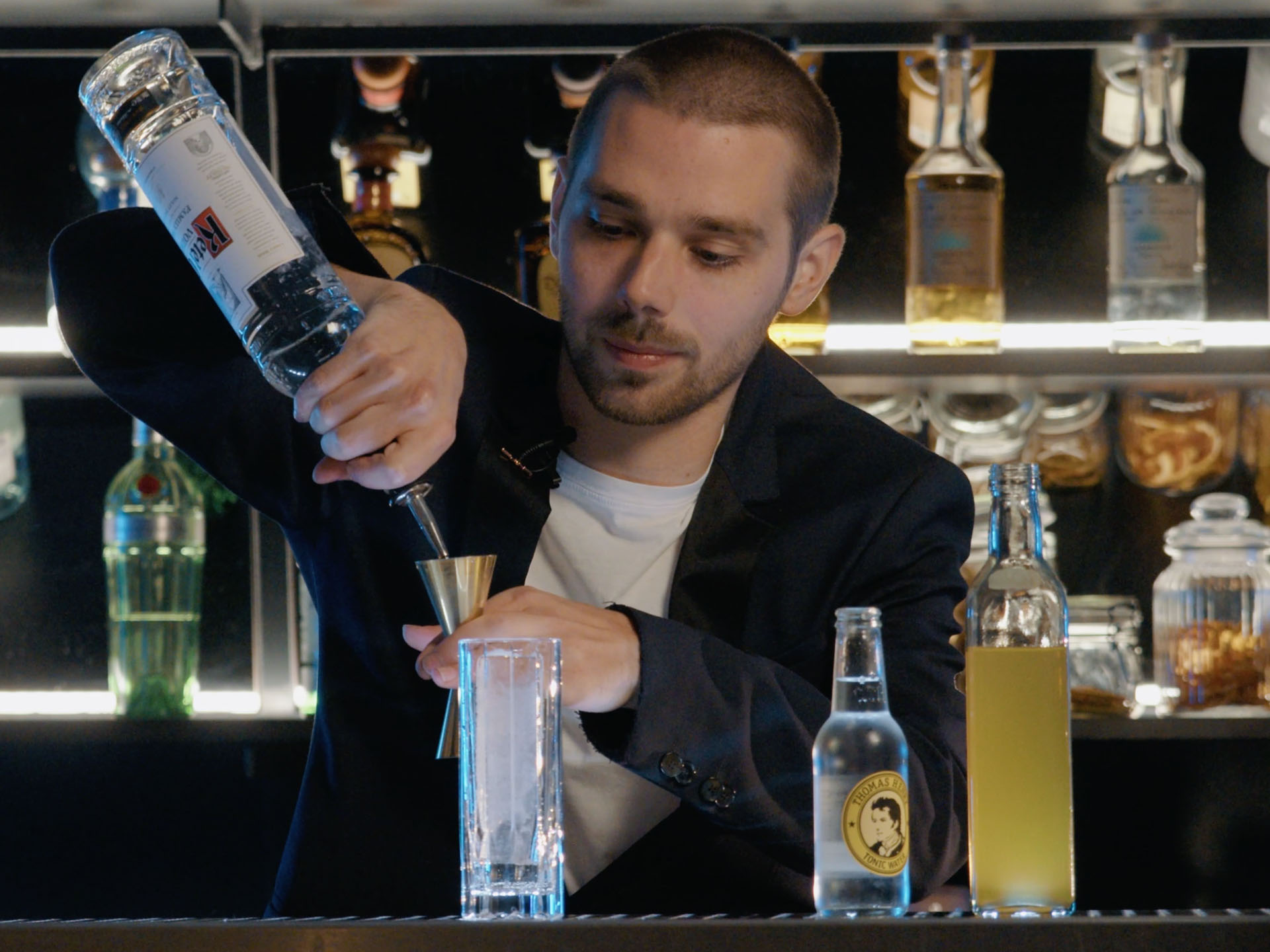 Dominik Oswald pouring Ketel One Vodka behind a bar