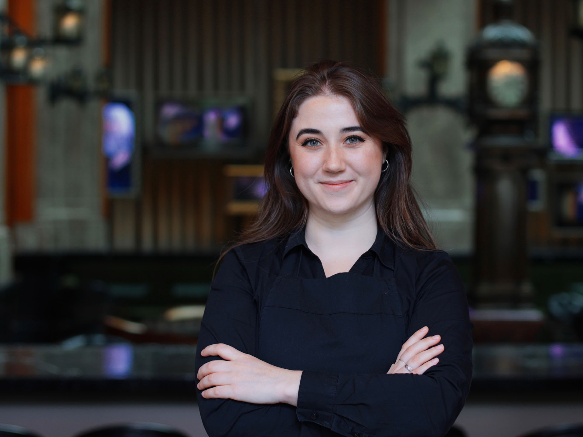 Laura Brady smiling with her arms folded