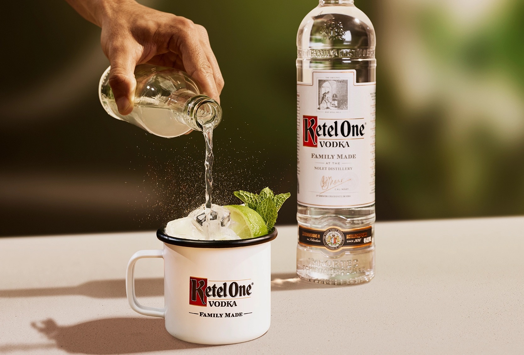 Ketel One Ketel One Mule in Enamel Mug with hand adding tonic