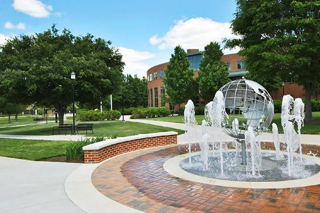 Photo of Harrisburg campus with a fountain in the foreground