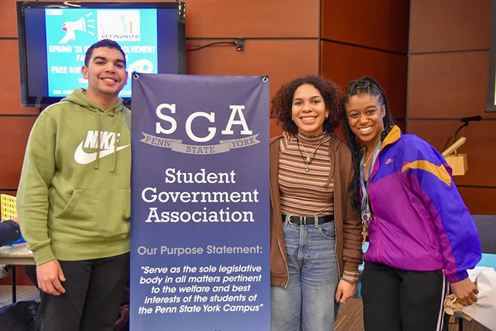 Photo of students standing together with a Student Government Association banner