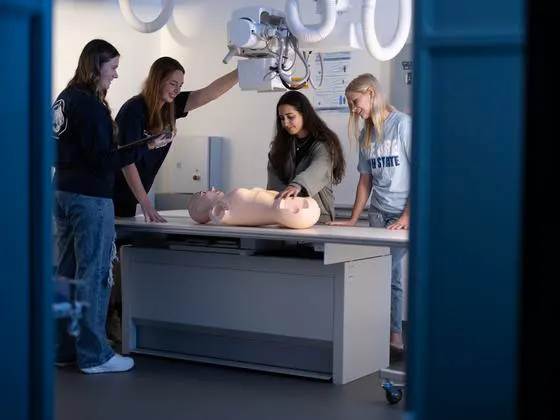 Photo of students working on a skills dummy in a science lab
