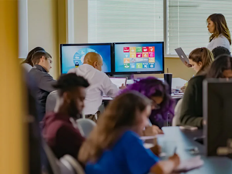 Instructor teaching in a classroom of students