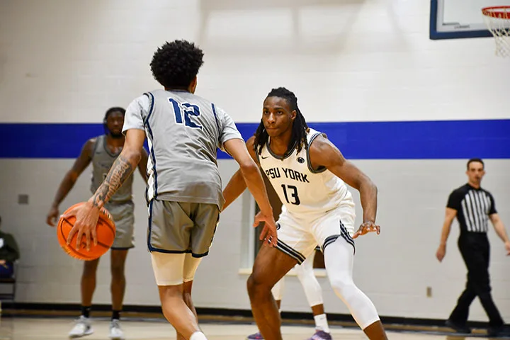 Photo of a player on the York men's basketball team dribbling in a game