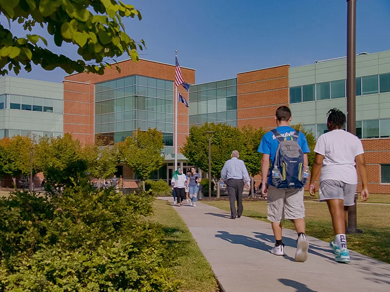 Two people talking to each other on a sidewalk at Penn State Lehigh Valley.