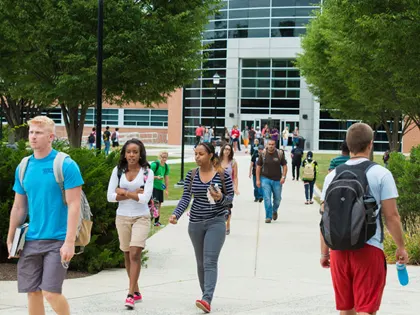 A large group of people walking on campus at Penn State Harrisburg.