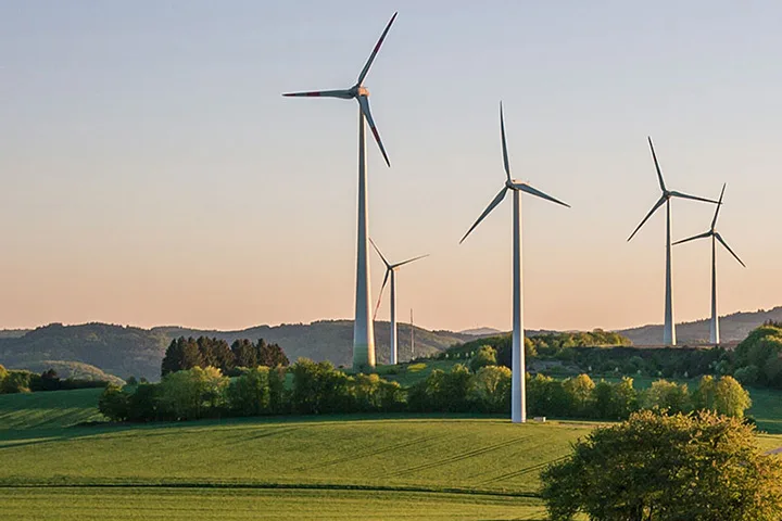 A photo of wind turbines on a hill