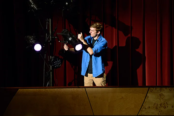 Photo of student working with stage lighting