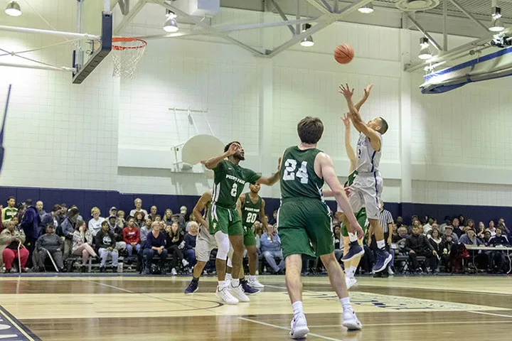 Photo of a Shenango men's basketball player shooting at a game