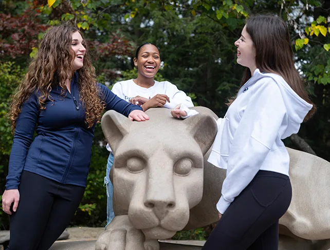 Penn State Student gather around the Nittany Lion shrine.