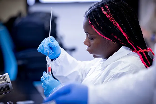 Photo of a student working in a biology classroom