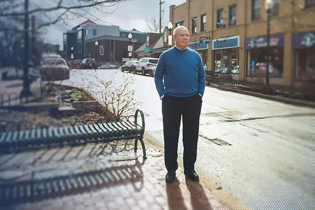 Tom Sharbaugh standing in front of storefronts 