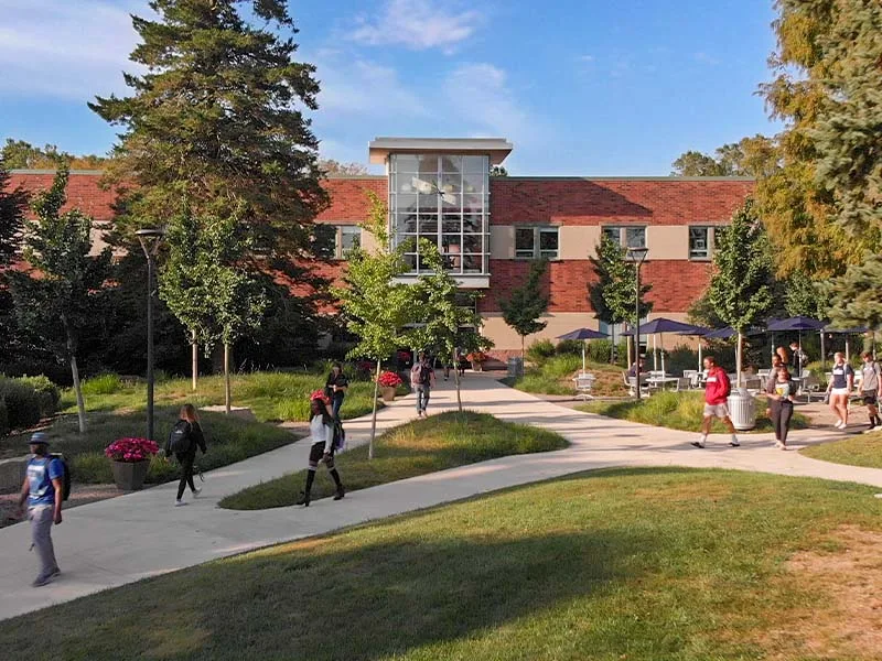 Exterior look at building on campus with students walking