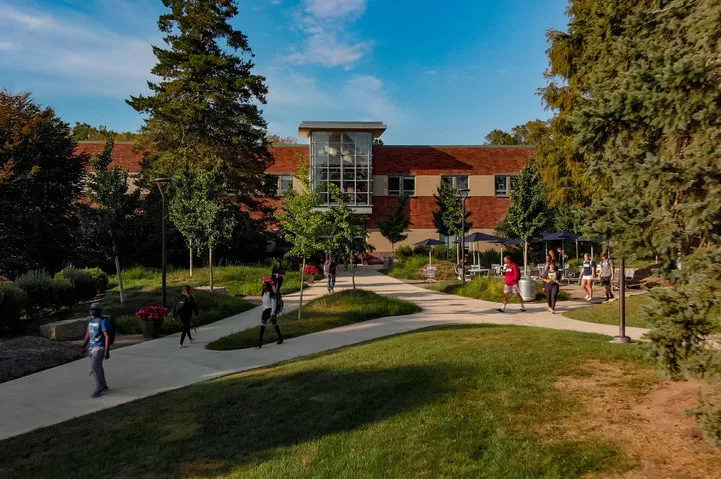 Exterior look at building on campus with students walking