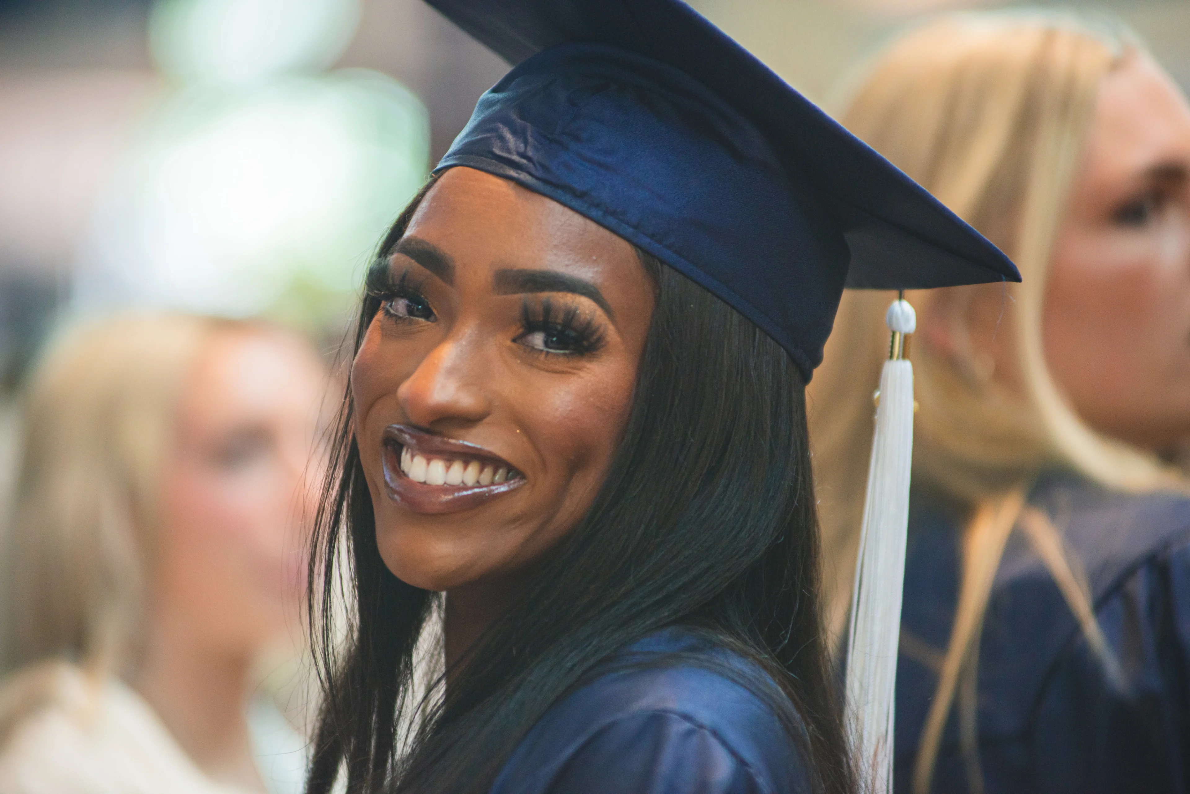 Penn State student in graduation cap and gown.