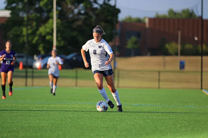 Photo of a Harrisburg women's soccer player dribbling during a game